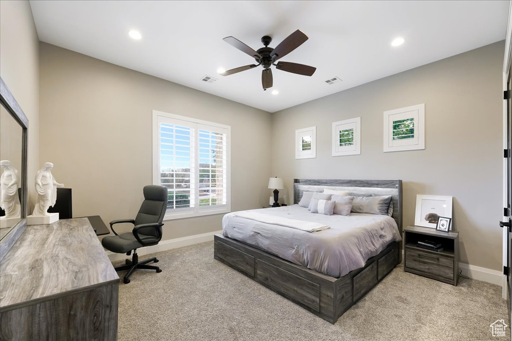 Carpeted bedroom featuring ceiling fan