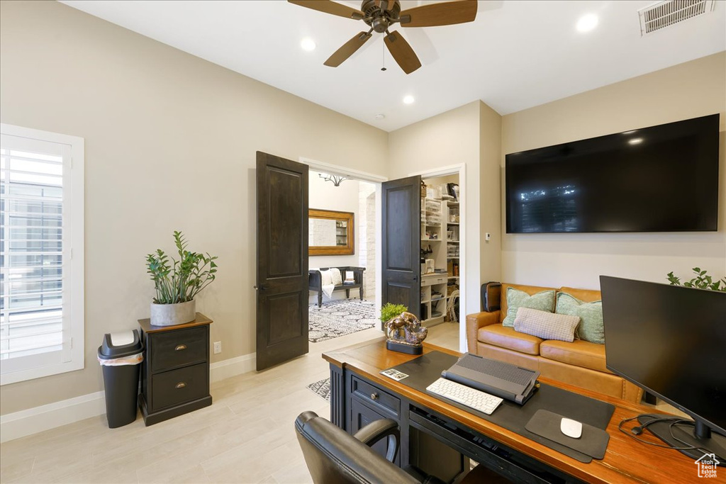 Office with ceiling fan and light hardwood / wood-style flooring