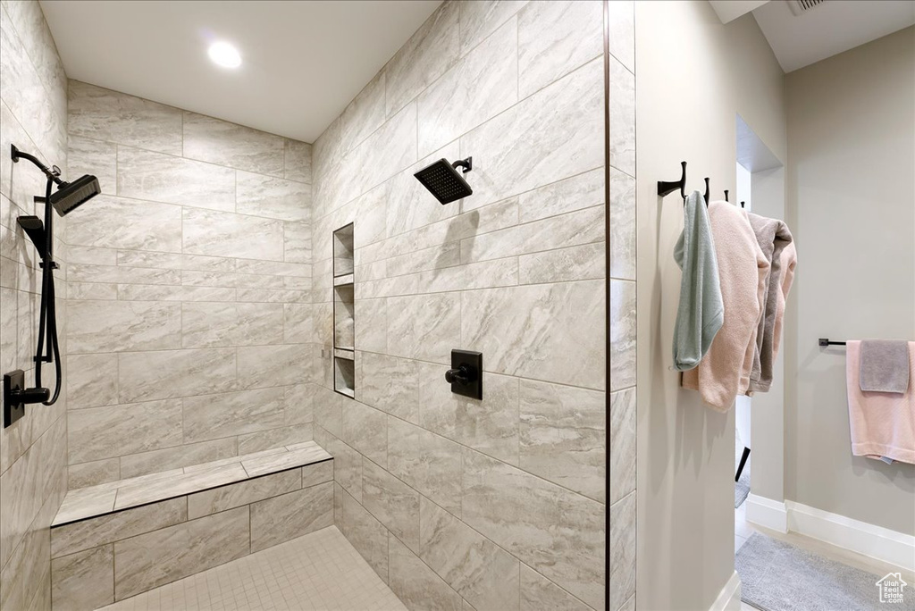 Bathroom featuring a tile shower