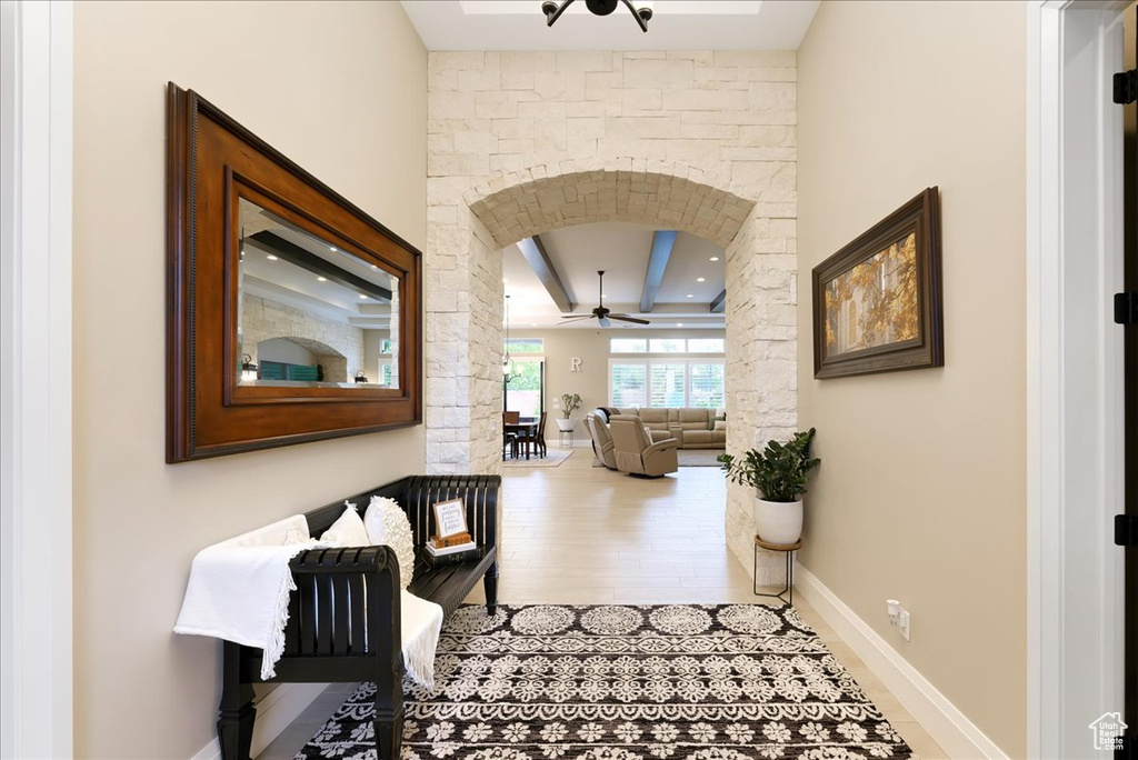 Hallway featuring beamed ceiling and hardwood / wood-style flooring