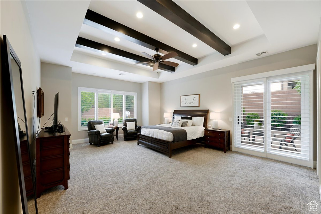 Carpeted bedroom with beam ceiling, multiple windows, access to exterior, and ceiling fan