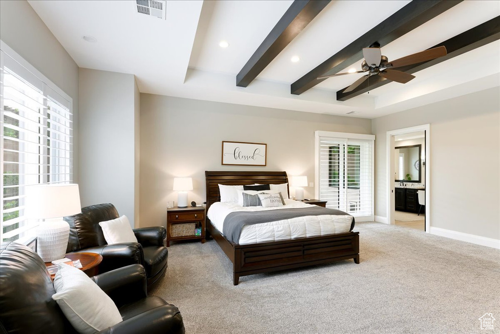 Carpeted bedroom featuring connected bathroom, beamed ceiling, and ceiling fan