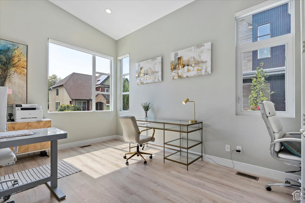 Home office featuring light hardwood / wood-style flooring and lofted ceiling