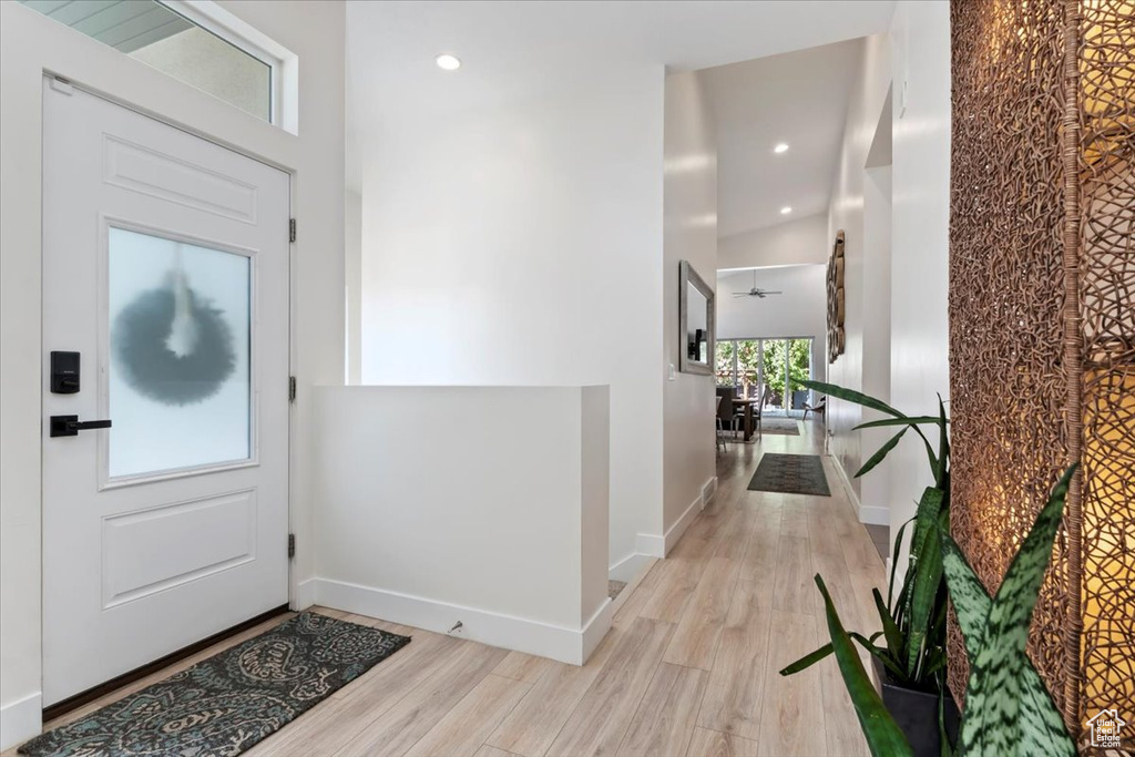 Foyer with ceiling fan and light wood-type flooring