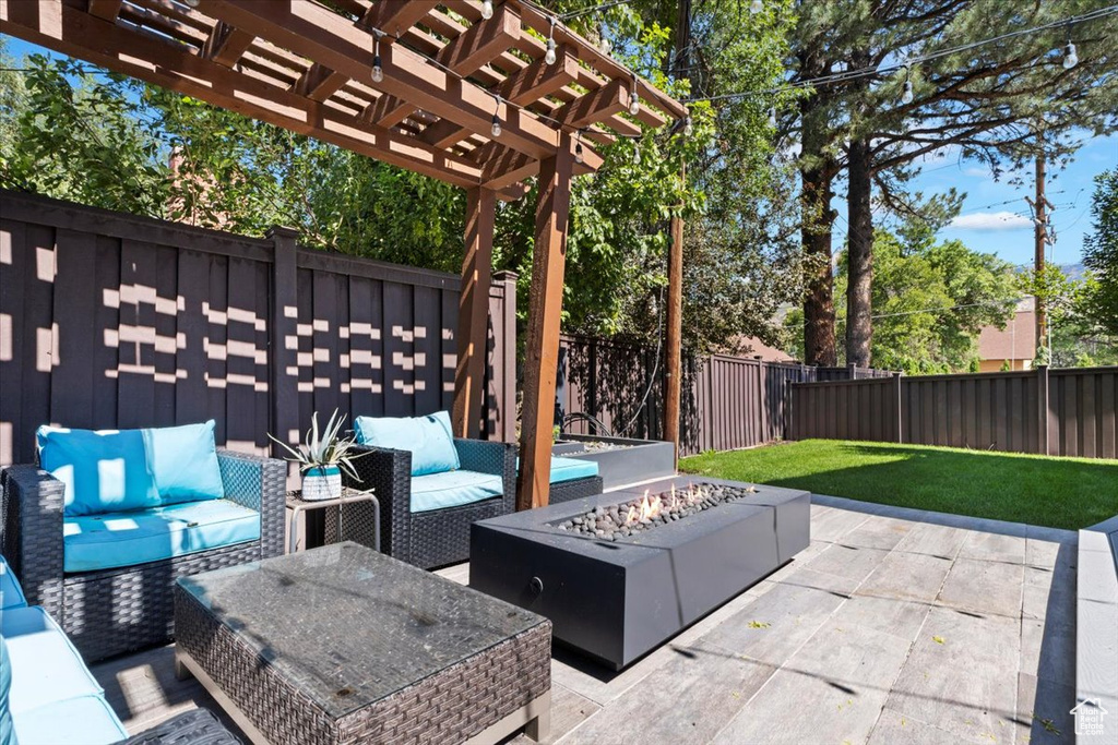 View of patio / terrace featuring an outdoor living space with a fire pit and a pergola