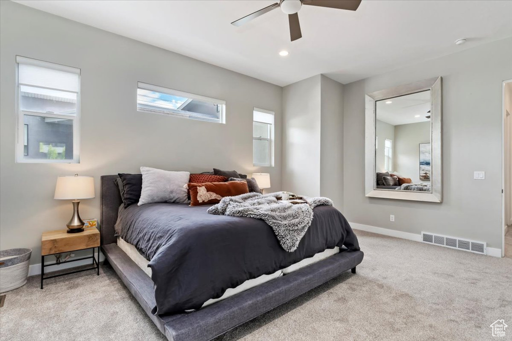 Carpeted bedroom with ceiling fan