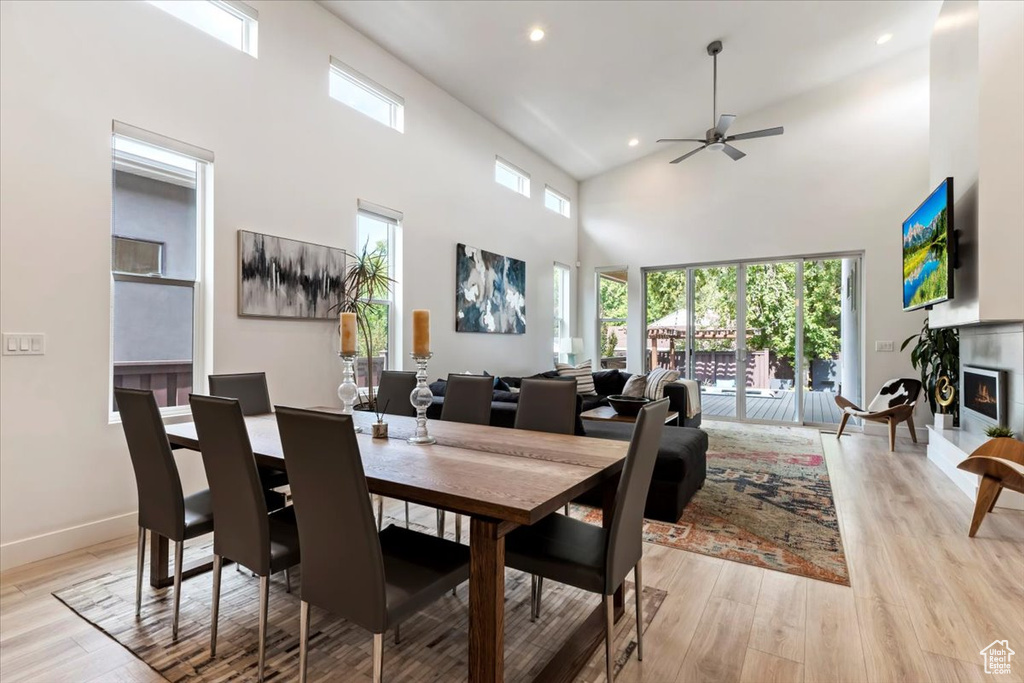 Dining area featuring ceiling fan, light hardwood / wood-style flooring, and high vaulted ceiling