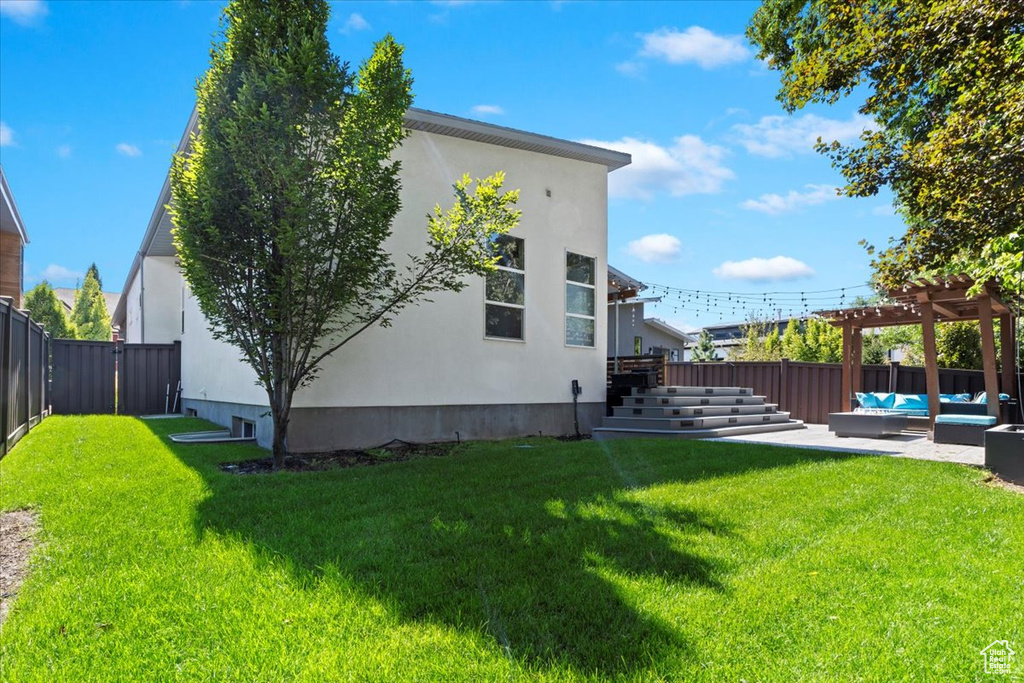 View of yard with a pergola, a patio area, and an outdoor hangout area