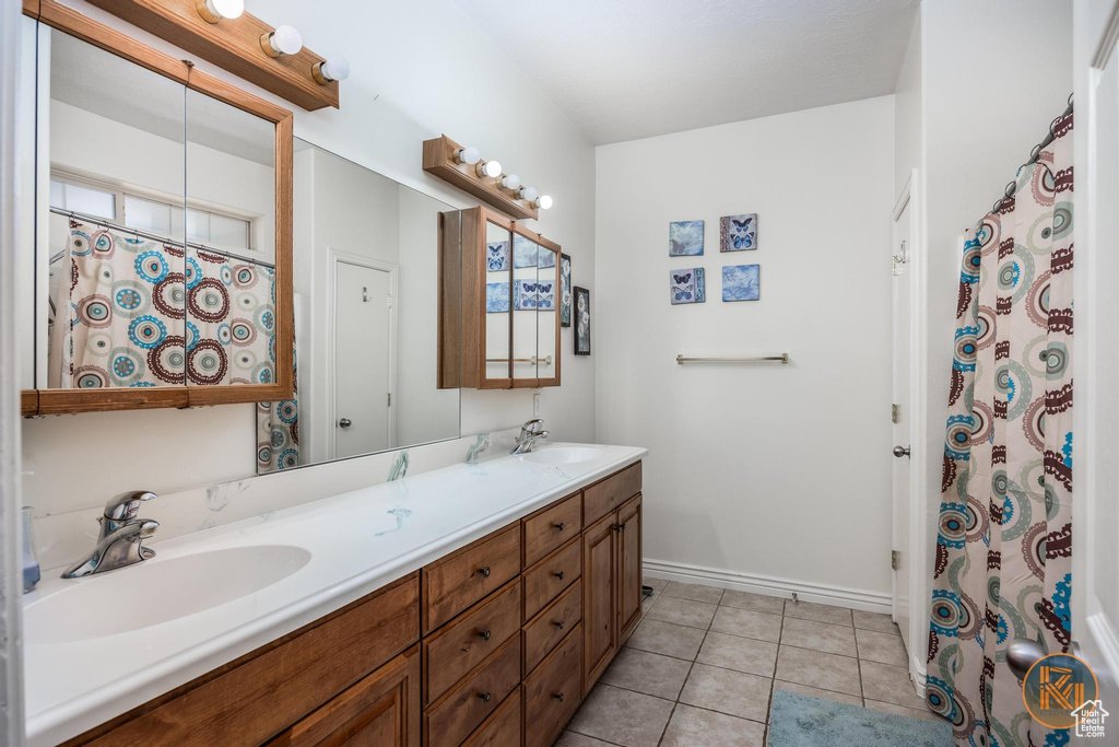 Bathroom featuring vanity and tile patterned flooring