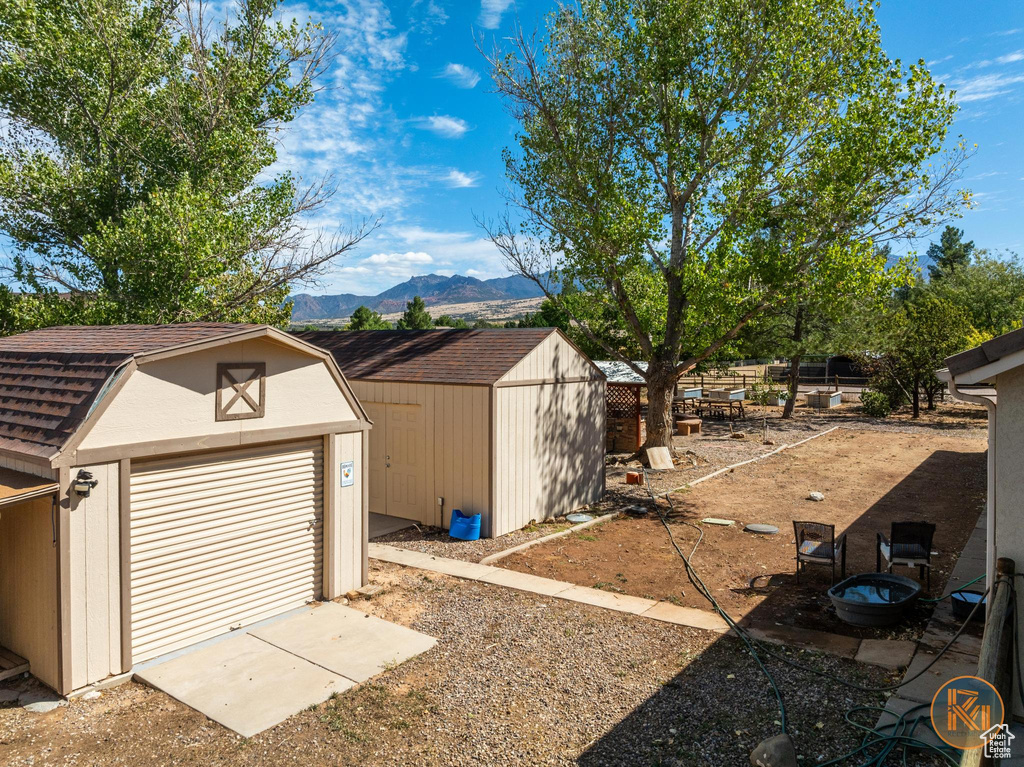 View of yard featuring a storage unit and a mountain view