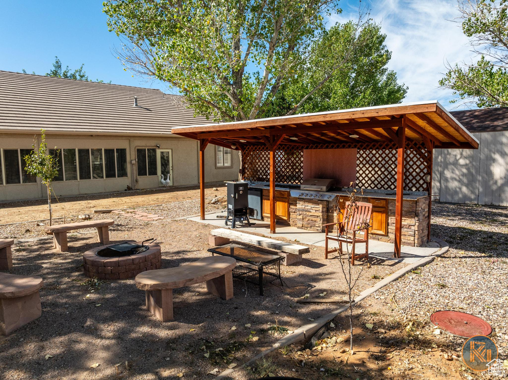 Exterior space with grilling area and an outdoor fire pit