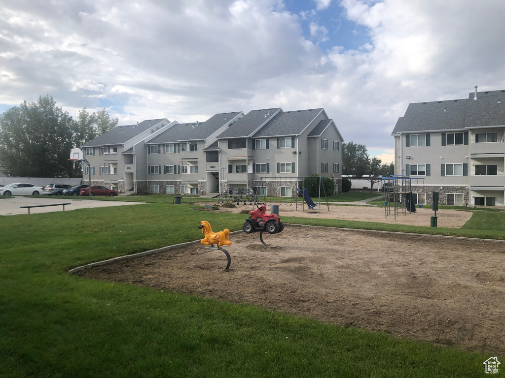 View of home's community featuring a playground and a yard