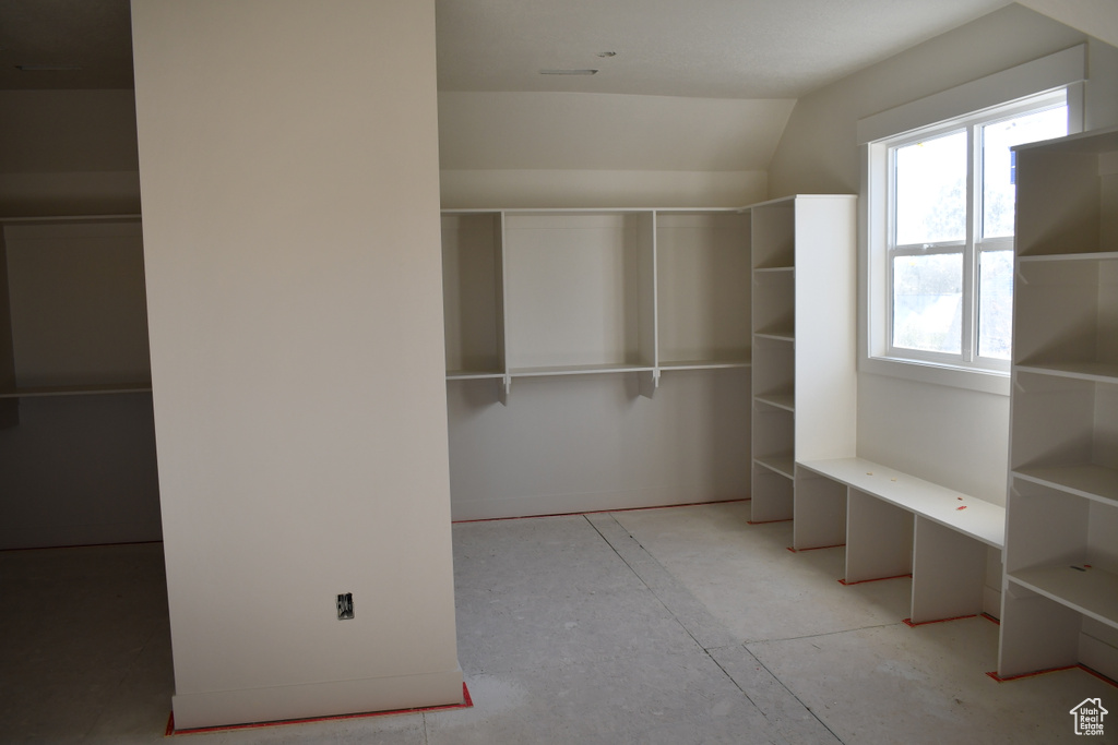 Walk in closet featuring vaulted ceiling