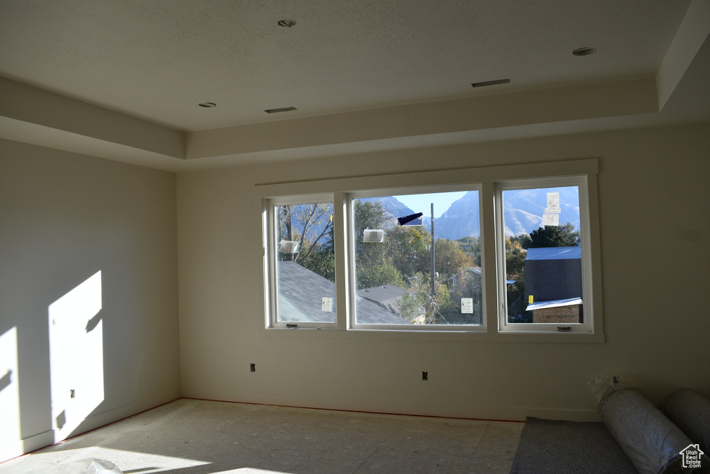 Interior space featuring a raised ceiling