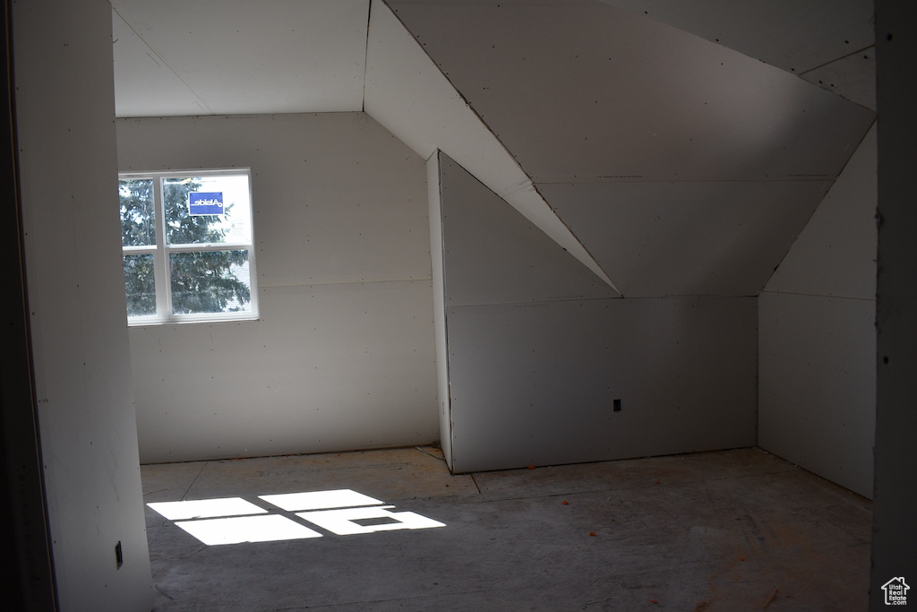 Additional living space featuring lofted ceiling