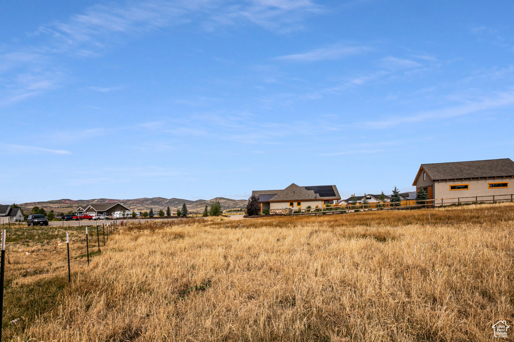 View of yard featuring a rural view and a mountain view