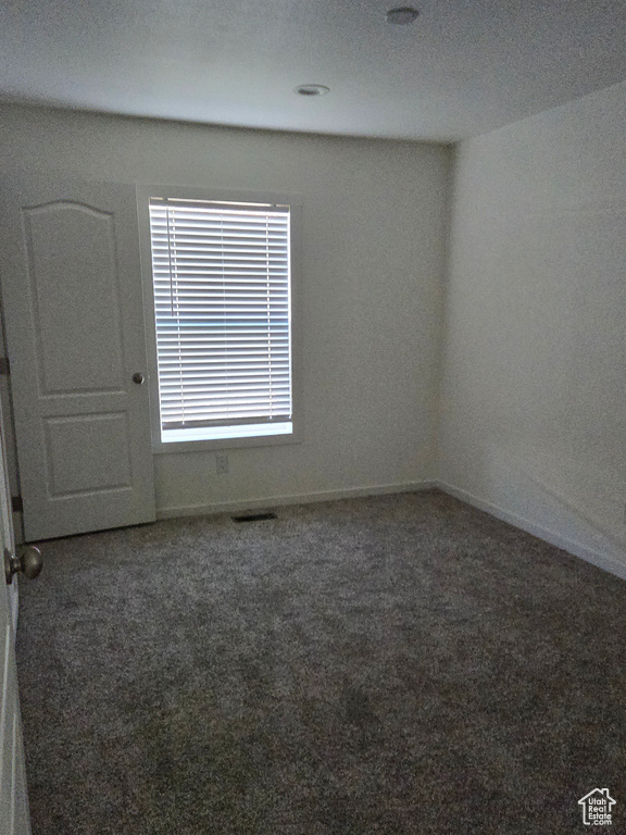 Carpeted spare room featuring a textured ceiling