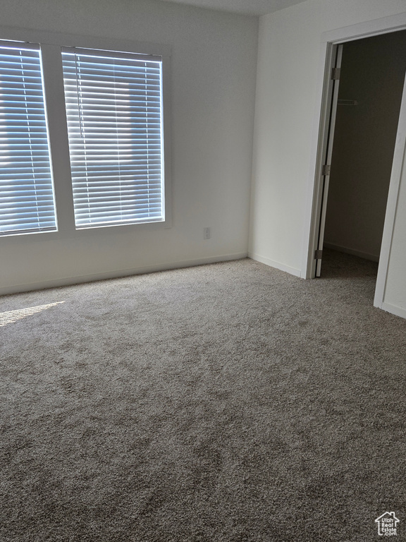 Unfurnished room featuring carpet flooring