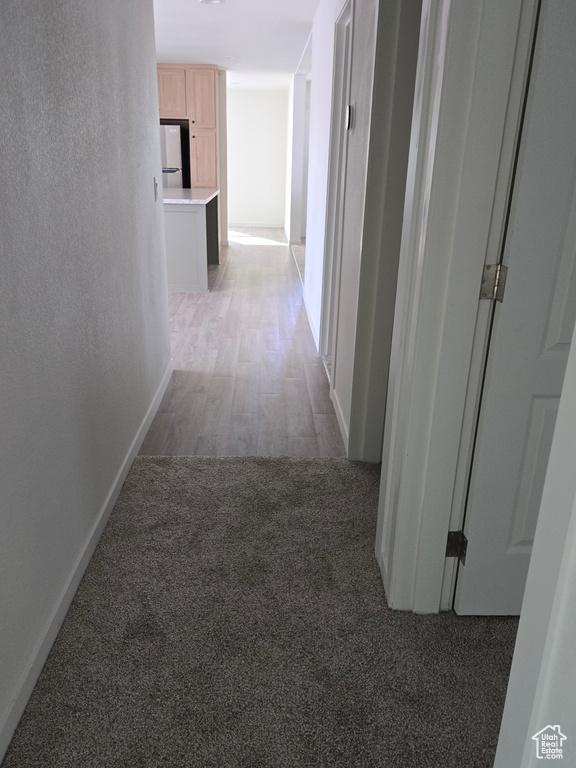 Hall with dark hardwood / wood-style flooring