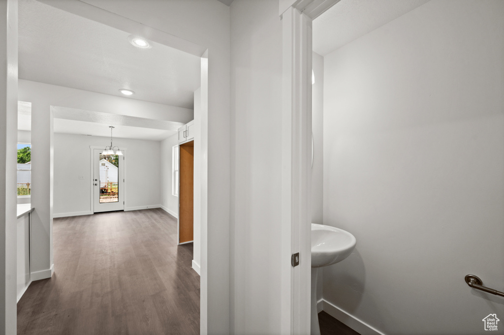 Bathroom featuring wood-type flooring and an inviting chandelier