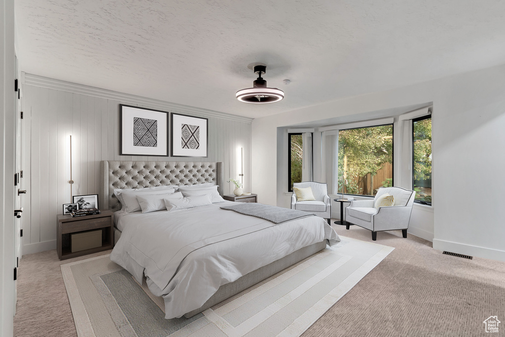 Carpeted bedroom with a textured ceiling