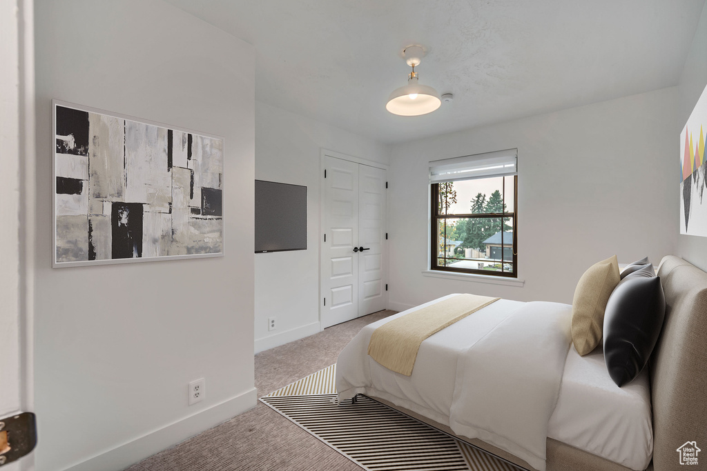 Carpeted bedroom featuring a closet