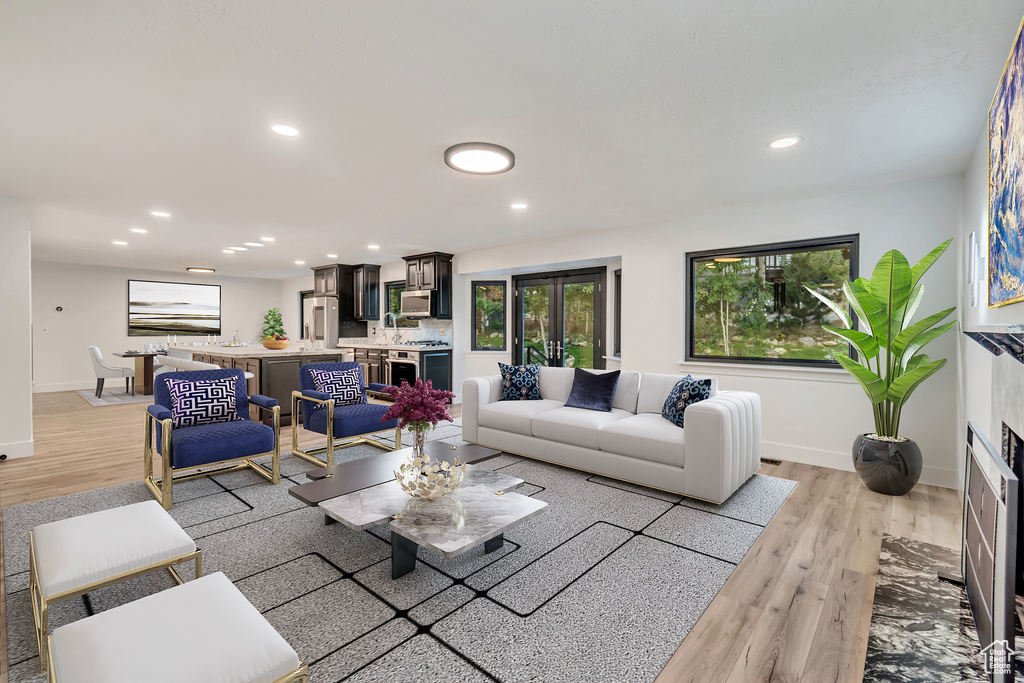 Living room featuring light wood-type flooring and a fireplace