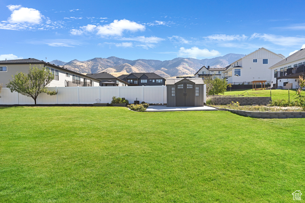 View of yard featuring a mountain view and a shed