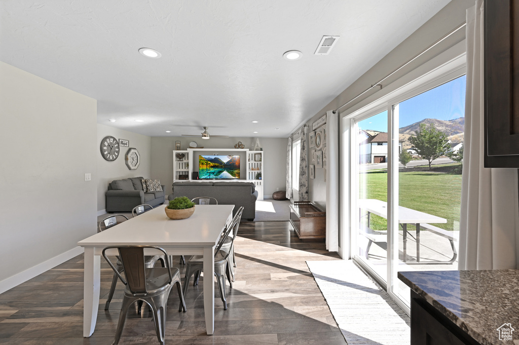 Dining space with ceiling fan and dark hardwood / wood-style floors