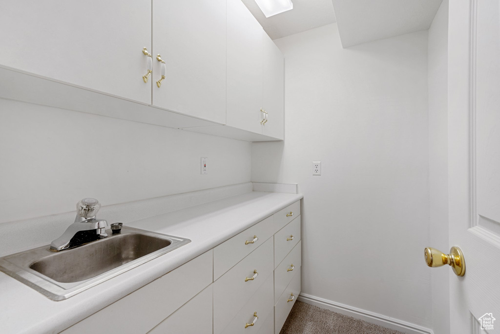 Kitchen with sink and white cabinetry