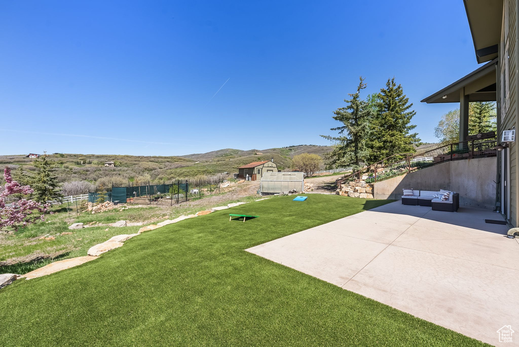 View of yard with a patio and a mountain view