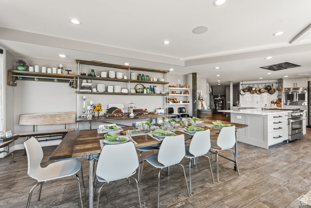 Dining room with light hardwood / wood-style flooring