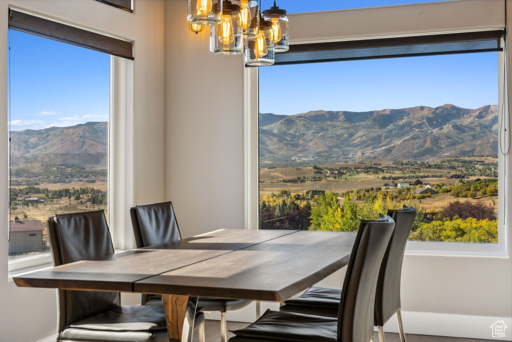 Dining area with a chandelier and a mountain view