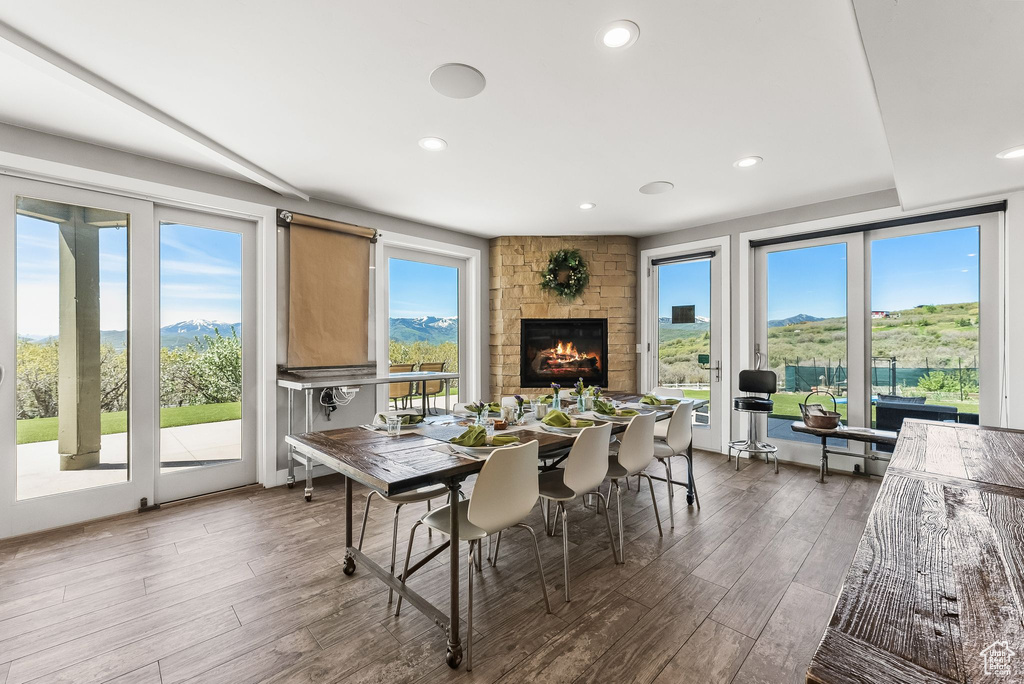 Dining room featuring a mountain view, a fireplace, and hardwood / wood-style floors