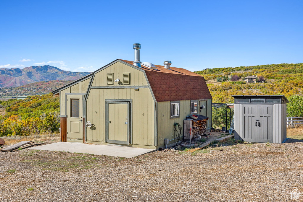 View of outbuilding with a mountain view