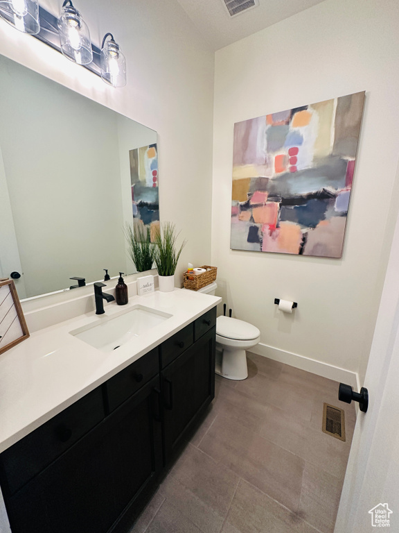 Bathroom with vanity, tile patterned flooring, and toilet