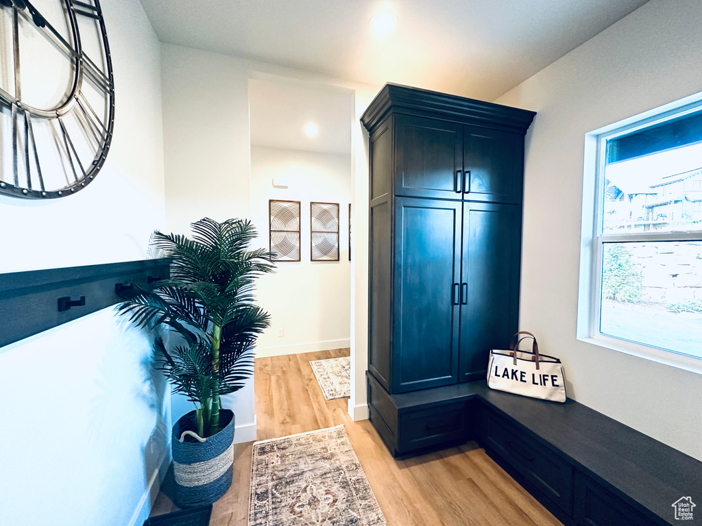 Mudroom with light hardwood / wood-style floors