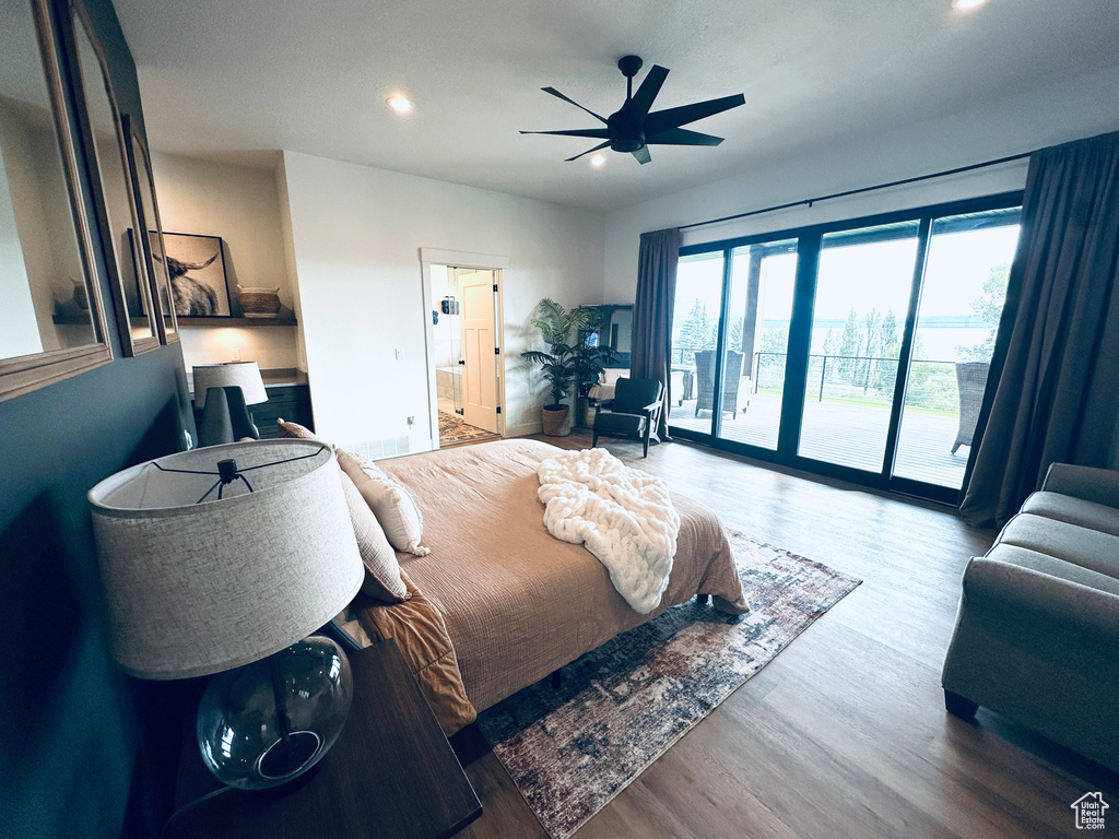 Bedroom featuring wood-type flooring, access to outside, and ceiling fan