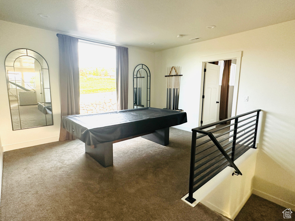 Playroom with dark carpet and pool table