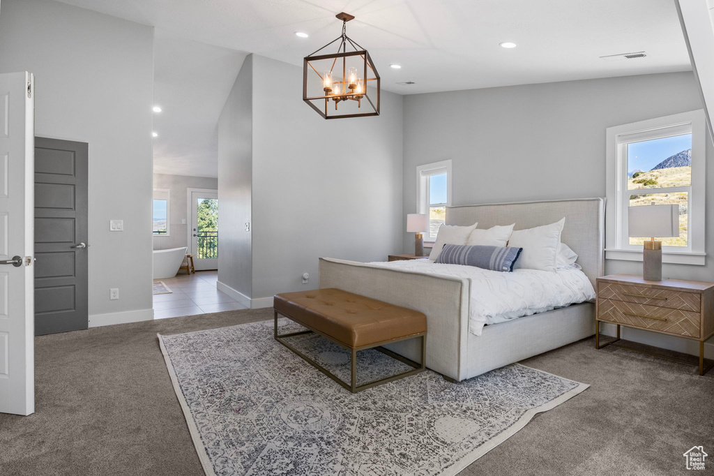 Bedroom with carpet, multiple windows, and a chandelier