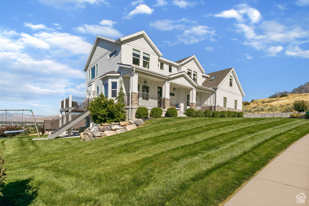 View of front of house with a trampoline and a front lawn