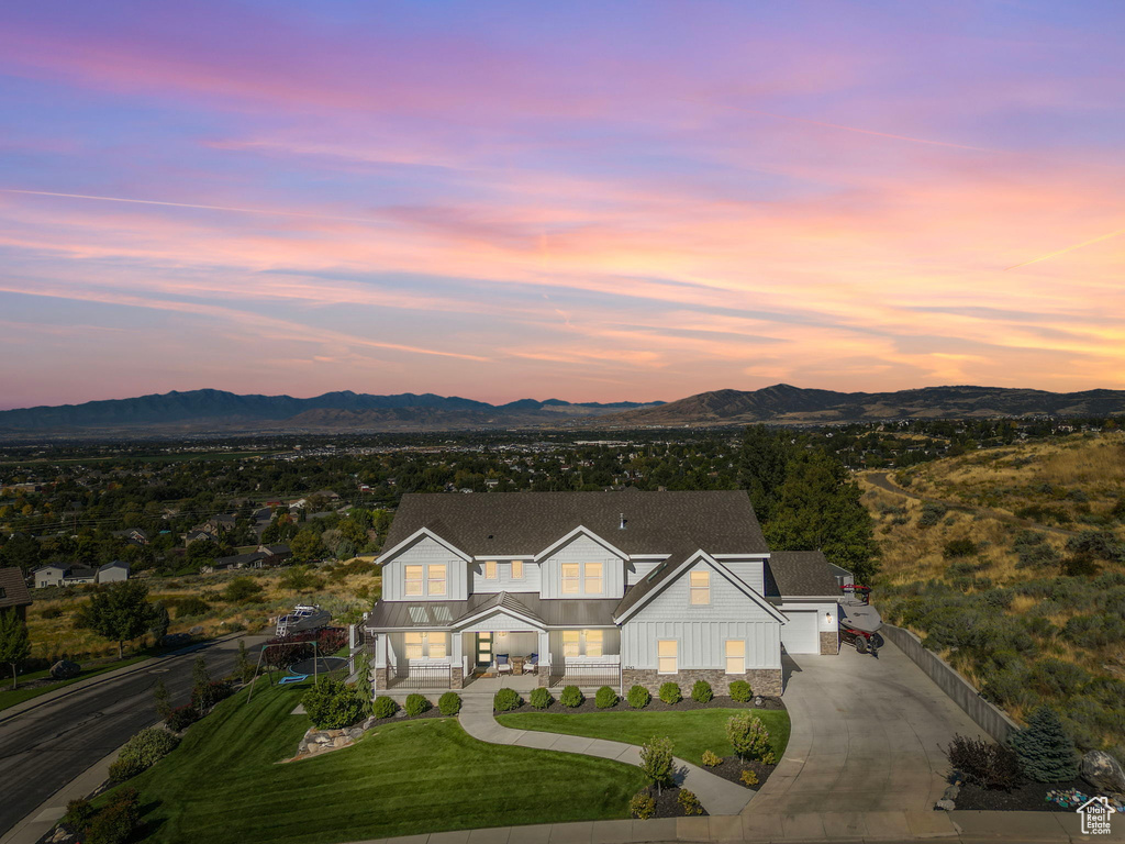 Aerial view at dusk featuring a mountain view