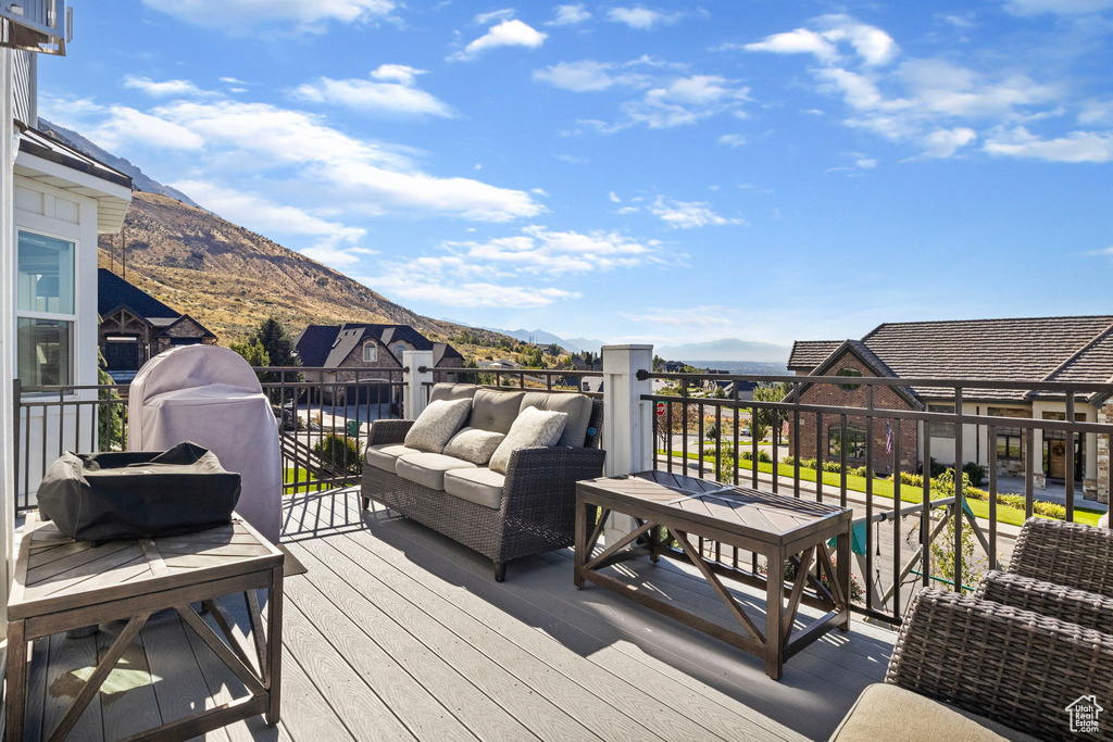 Deck with a mountain view and outdoor lounge area