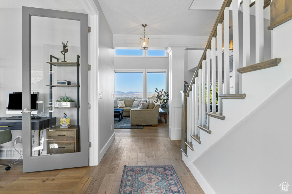 Entryway featuring decorative columns and hardwood / wood-style flooring