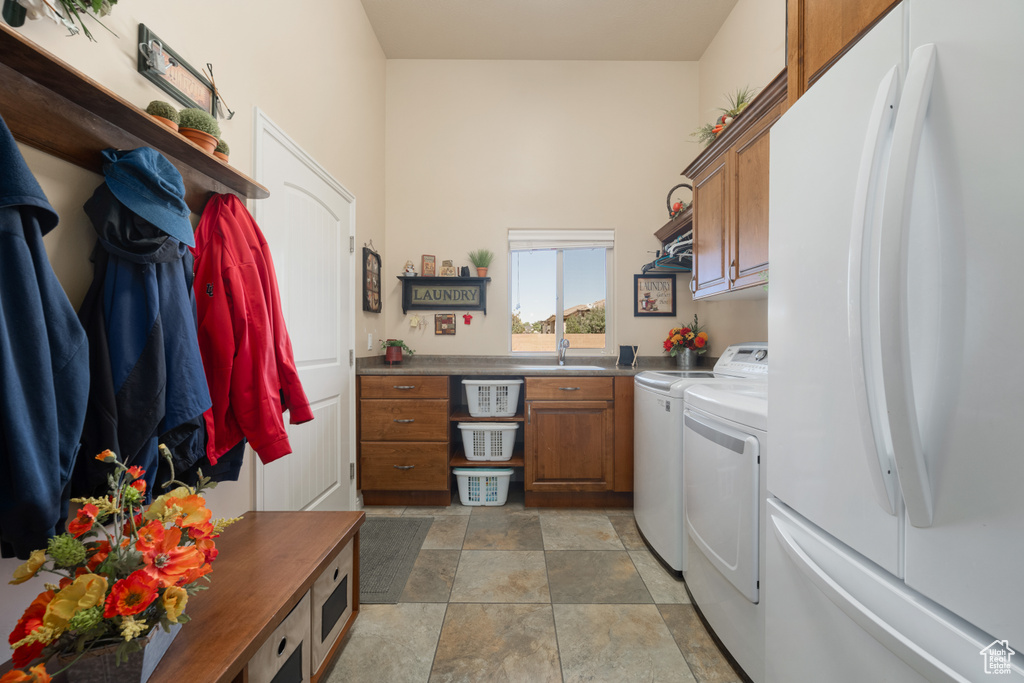 Interior space featuring white refrigerator and washer and clothes dryer