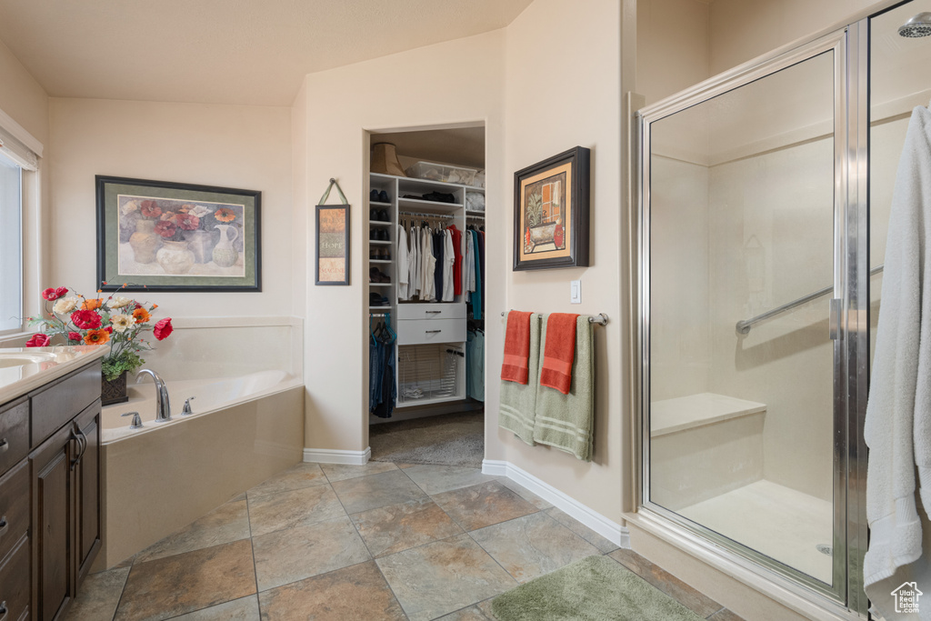 Bathroom featuring independent shower and bath and vanity