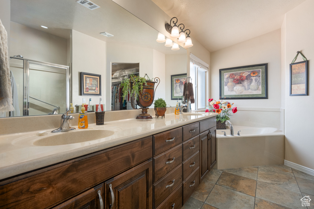 Bathroom featuring lofted ceiling, vanity, and plus walk in shower