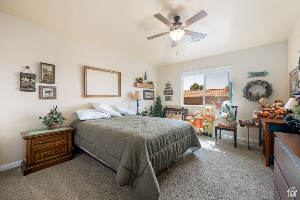 Bedroom with ceiling fan and light carpet