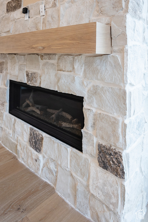 Interior details with a stone fireplace and hardwood / wood-style floors