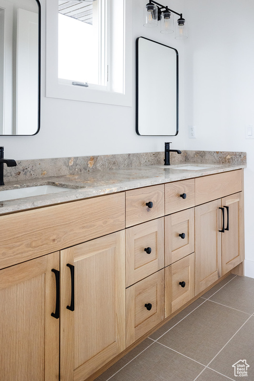 Bathroom with tile patterned floors and vanity